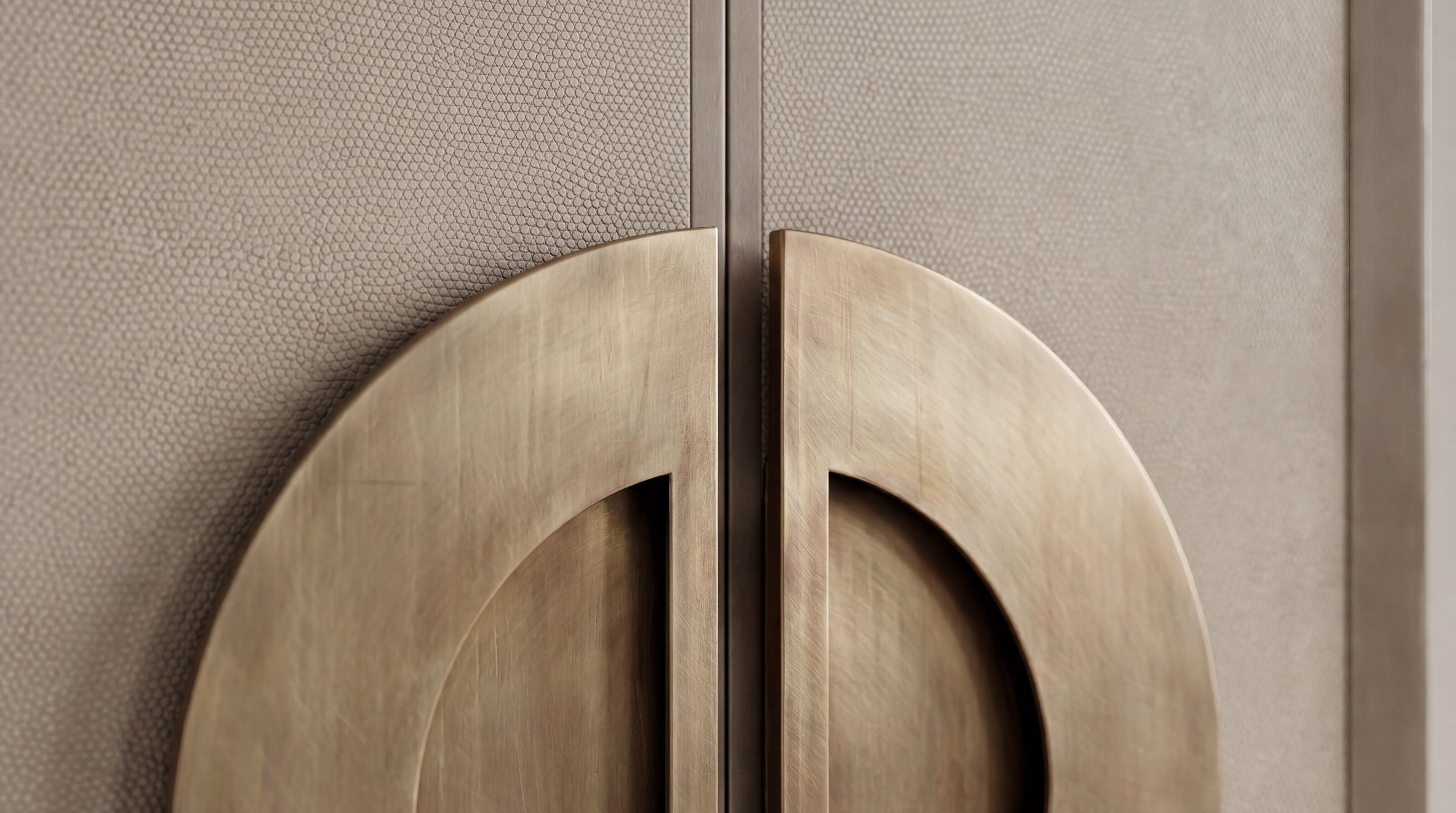 Close-up of the textured cabinet door and brushed brass circular handle